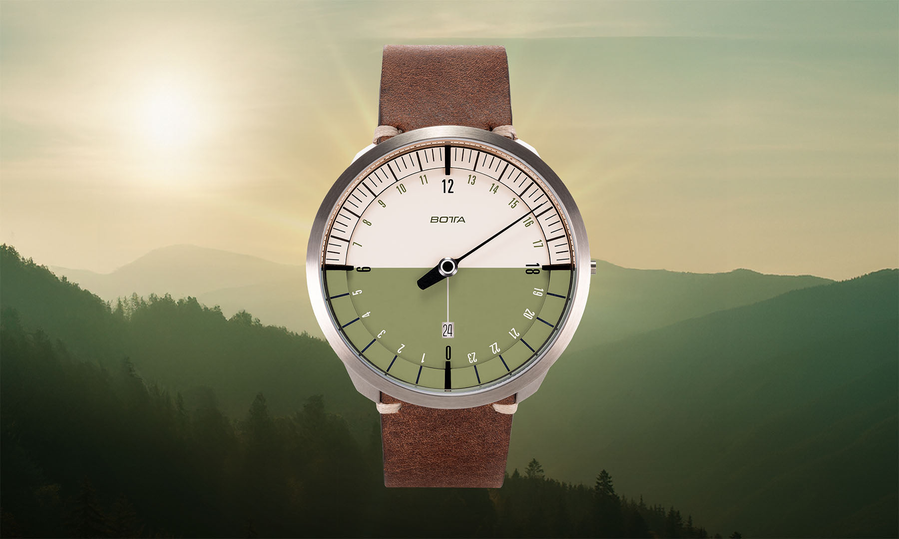 Vor einer sonnendurchfluteten Berglandschaft präsentiert sich die BOTTA UNO 24 Your Time Olive Quarzuhr. Diese hochwertige 24-Stunden Uhr mit einem Zeiger zeigt den gesamten Tagesverlauf in einer olivgrün-beigen Tag-Nacht-Grafik. Als Einzeigeruhr verbindet sie minimalistisches Design mit der Präzision eines Titan-Quarzwerks. Eine außergewöhnliche Armbanduhr mit einem Zeiger für bewusstes Zeitverständnis. Jetzt kaufen oder bestellen.